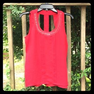 Red sleeveless tank, embellished neck.